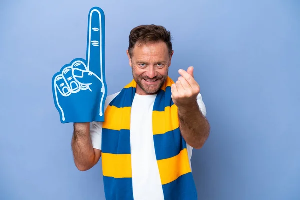 Middle age caucasian sports fan man isolated on blue background making money gesture
