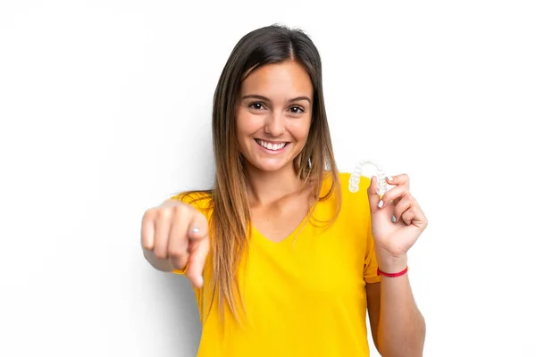 Young Caucasian Woman Holding Invisible Braces Isolated White Background Points — стоковое фото
