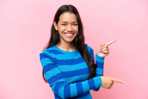 Young Colombian Woman Isolated Pink Background Pointing Finger Side Presenting —  Fotos de Stock