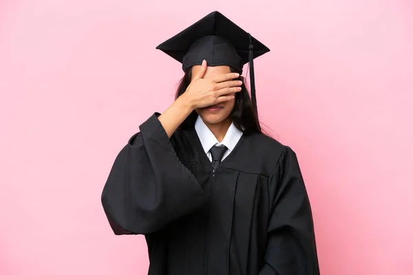 Young university Colombian woman graduate isolated on pink background covering eyes by hands. Do not want to see something