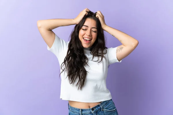 Young caucasian woman isolated on purple background laughing