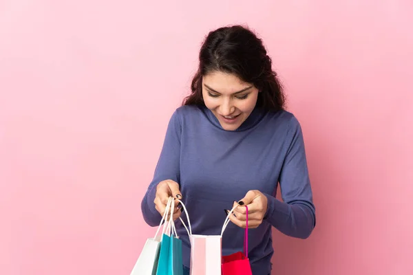 Teenager Russian Girl Isolated Pink Background Holding Shopping Bags Looking — Stockfoto