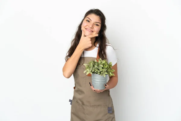 Young Russian Gardener Girl Holding Plant Isolated Happy Smiling — Stockfoto