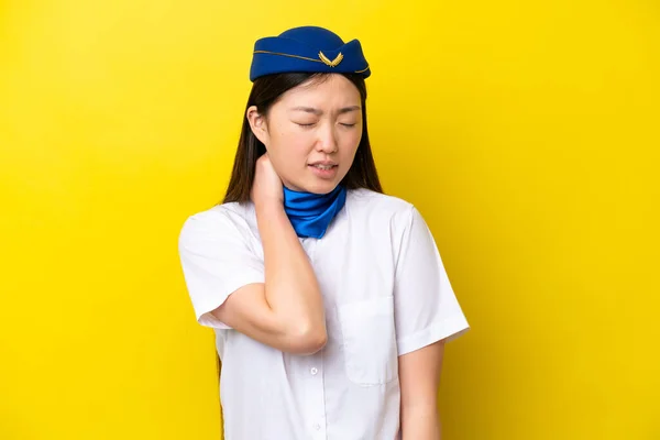 Airplane Chinese woman stewardess isolated on yellow background with neckache