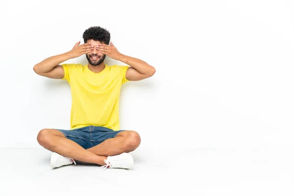 Young Moroccan Handsome Man Sitting Floor Isolated Background Covering Eyes — Stockfoto