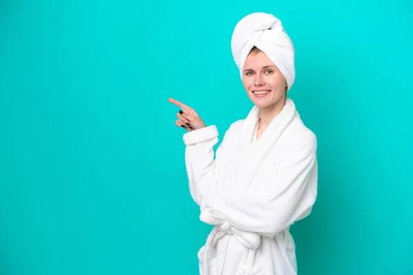 Young Woman Bathrobe Isolated Blue Background Pointing Finger Side — 图库照片