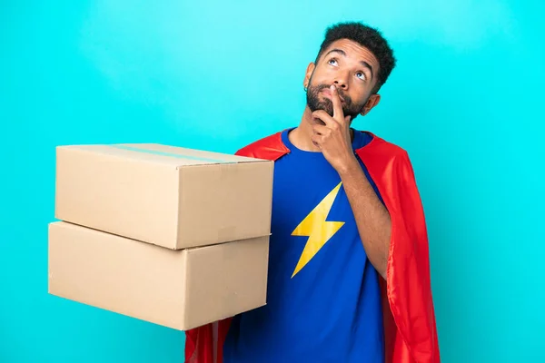 Super Hero Delivery Brazilian Man Isolated Blue Background Having Doubts — Stock Photo, Image