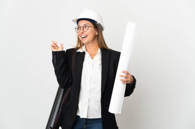 Miğferli orta yaşlı bir mimar kadın ve izole edilmiş arka plan üzerinde planları var. Çözümün ne olduğunu anlamak için parmağını kaldırıyor.