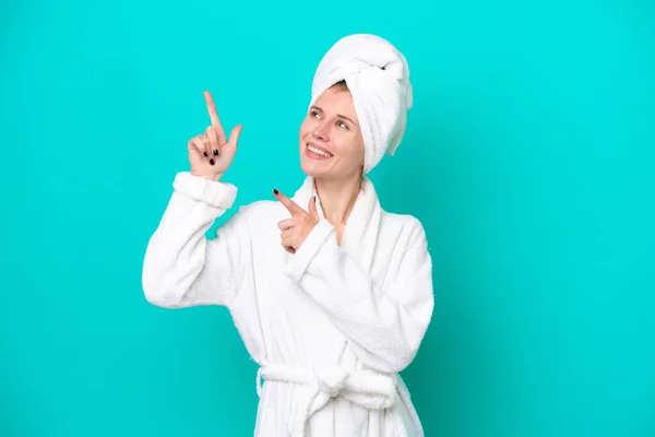 Young Woman Bathrobe Isolated Blue Background Pointing Index Finger Great — 图库照片