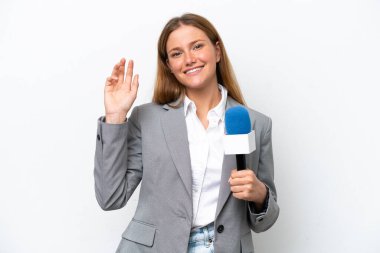 Young caucasian tv presenter woman isolated on white background saluting with hand with happy expression
