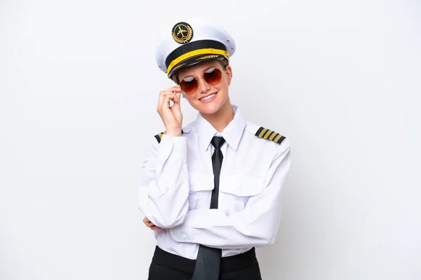 Airplane caucasian pilot woman isolated on white background with glasses and happy