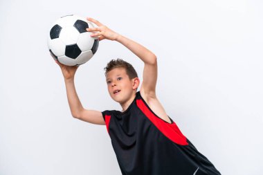 Boy playing football over isolated white wall