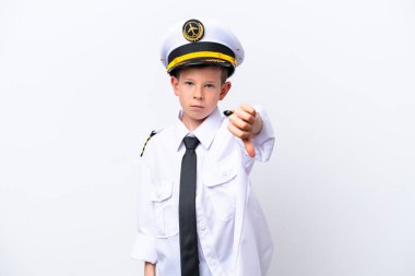 Little airplane pilot boy isolated on white background showing thumb down with negative expression