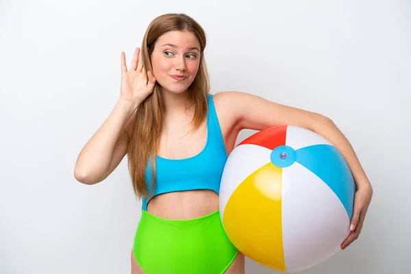 Young Woman Holding Beach Ball Holidays Isolated White Background Listening — Stok fotoğraf