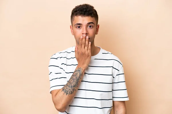 Young Brazilian Man Isolated Beige Background Covering Mouth Hand — Stockfoto