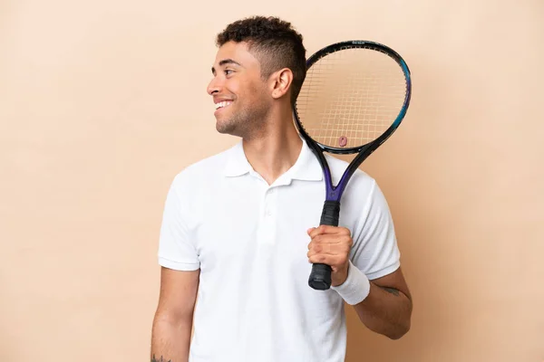 Young Brazilian Handsome Man Playing Tennis Isolated Beige Background Looking — Stockfoto