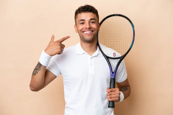 Young Brazilian Handsome Man Playing Tennis Isolated Beige Background Giving — Stockfoto