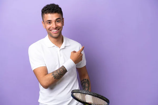 Молодий Бразільський Чоловік Ізольований Фіолетовому Фоні Грає Теніс Вказує Бічний — стокове фото