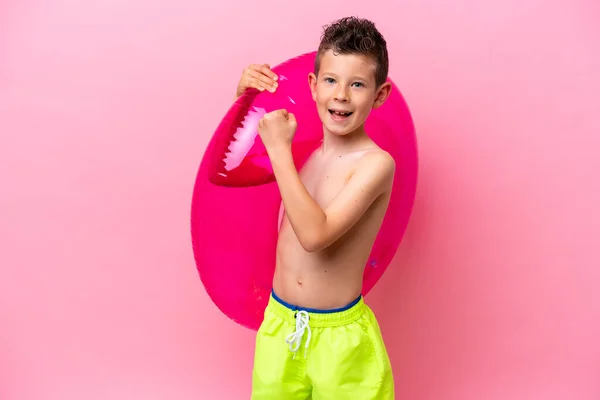 Little Caucasian Boy Holding Inflatable Donut Isolated Pink Background Celebrating — Stock Fotó