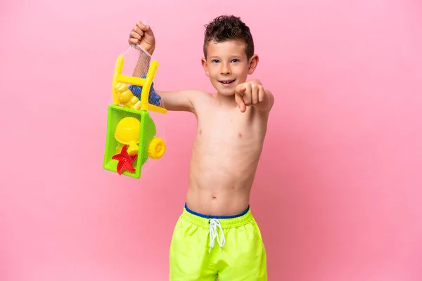 Little Caucasian Boy Holding Beach Toys Isolated Pink Background Surprised — Stockfoto