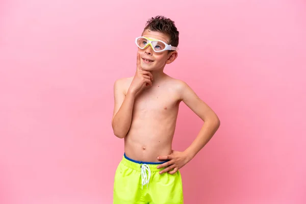 Little Caucasian Boy Wearing Diving Goggles Isolated Pink Background Thinking — Φωτογραφία Αρχείου