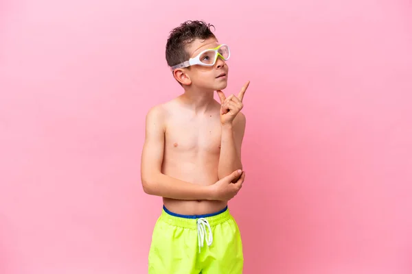 Little Caucasian Boy Wearing Diving Goggles Isolated Pink Background Pointing — Photo