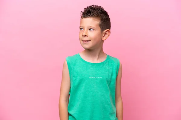 Little Caucasian Boy Isolated Pink Background Looking Side Smiling —  Fotos de Stock