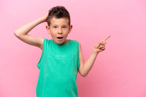 Little Caucasian Boy Isolated Pink Background Surprised Pointing Finger Side —  Fotos de Stock