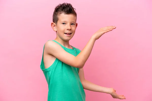 Little Caucasian Boy Isolated Pink Background Holding Copyspace Insert — Zdjęcie stockowe