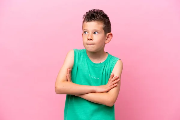 Little Caucasian Boy Isolated Pink Background Making Doubts Gesture While — Fotografia de Stock
