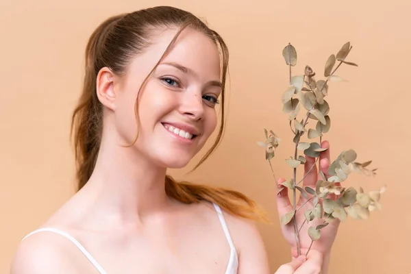 Young Caucasian Girl Isolated Beige Background Holding Eucalyptus Branch While — Stock Photo, Image