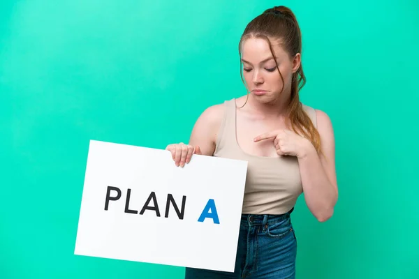 Young Caucasian Woman Isolated Green Background Holding Placard Message Plan — Stock Fotó