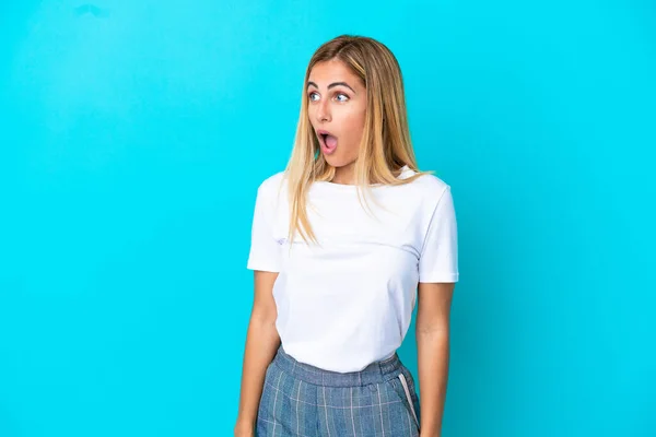 Blonde Uruguayan Girl Isolated Blue Background Doing Surprise Gesture While — Stock Photo, Image