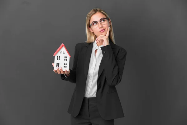 Blonde Uruguayan Girl Holding House Toy Isolated Black Background Having —  Fotos de Stock