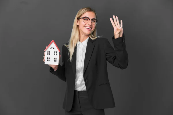 Blonde Uruguayan Girl Holding House Toy Isolated Black Background Happy — Stock Fotó