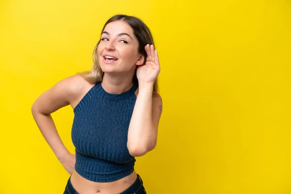 Young Rumanian Woman Isolated Yellow Background Listening Something Putting Hand — 스톡 사진
