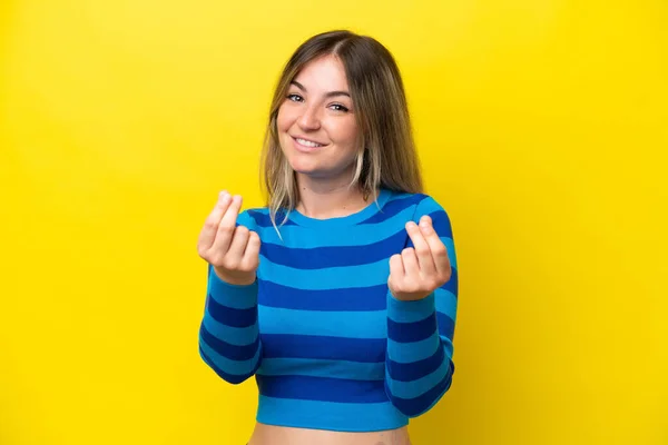 Young Rumanian Woman Isolated Yellow Background Making Money Gesture — Zdjęcie stockowe