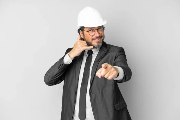 Young Architect Man Helmet Isolated Background Making Phone Gesture Pointing — Stockfoto