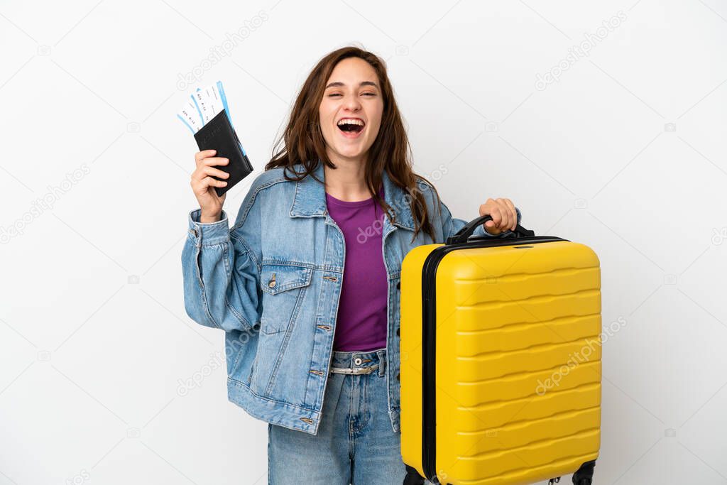 Young caucasian woman isolated on white background in vacation with suitcase and passport