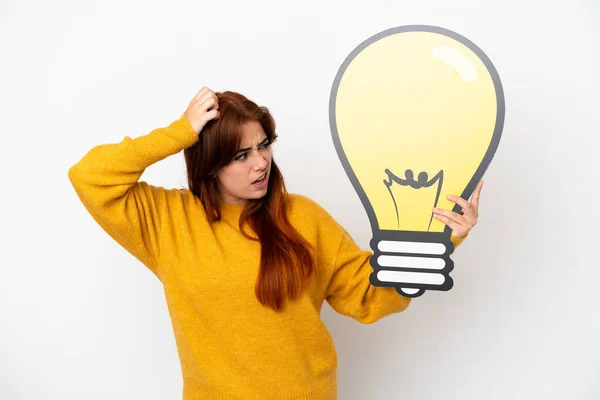 Young Redhead Woman Isolated White Background Holding Bulb Icon Having — Stock fotografie