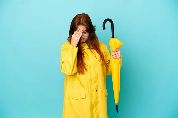 Redhead Woman Holding Umbrella Isolated Blue Background Tired Sick Expression —  Fotos de Stock