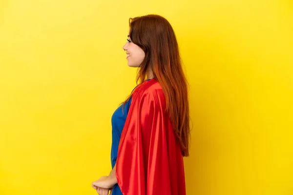 Super Hero Redhead Woman Isolated Yellow Background Lateral Position — Stock fotografie