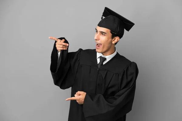 Young Argentinian University Graduate Isolated Grey Background Pointing Finger Side — Stock Fotó