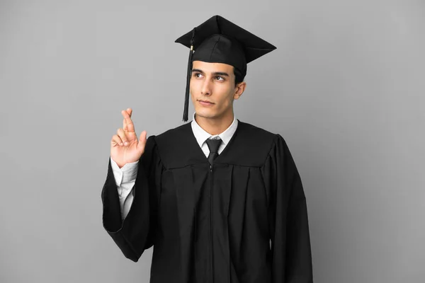 Young Argentinian University Graduate Isolated Grey Background Fingers Crossing Wishing — ストック写真