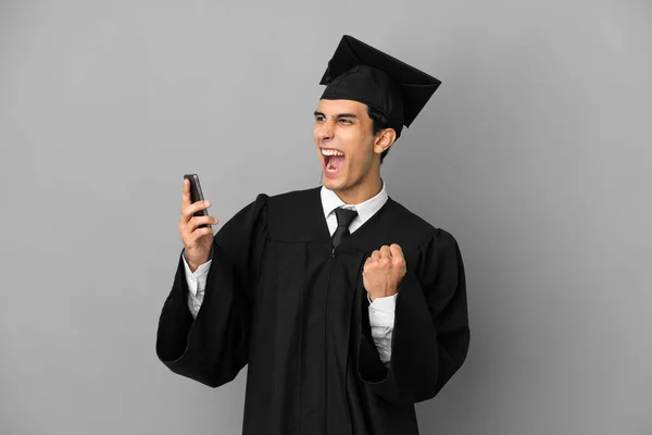 Young Argentinian University Graduate Isolated Grey Background Phone Victory Position — Foto Stock