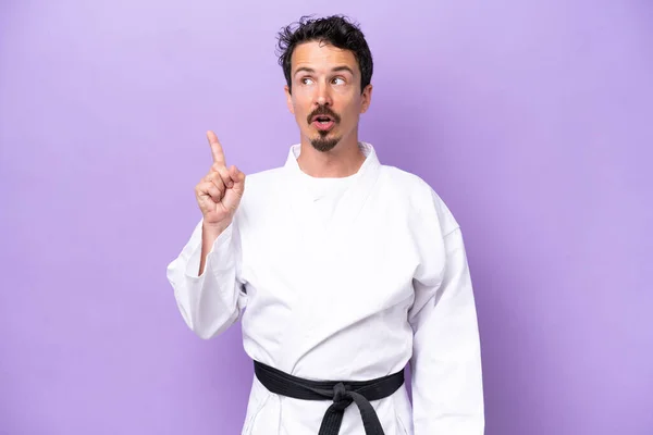 Young Caucasian Man Doing Karate Isolated Purple Background Thinking Idea — Stock fotografie