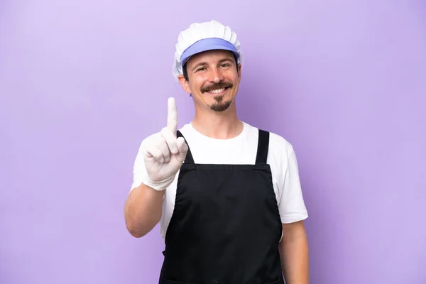 Fishmonger Man Wearing Apron Isolated Purple Background Showing Lifting Finger — Photo