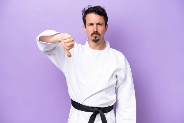 Young Caucasian Man Doing Karate Isolated Purple Background Showing Thumb — Stock fotografie