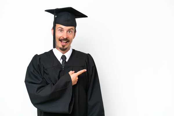Young University Graduate Man Isolated White Background Surprised Pointing Side — Foto Stock