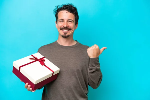 Young Man Holding Gift Pointing Side Present Product — Stock Fotó